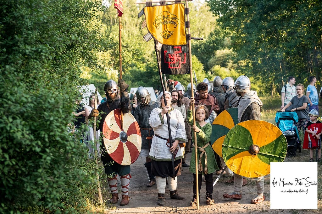 Pochód drużyny wojów niosących sztandar.
